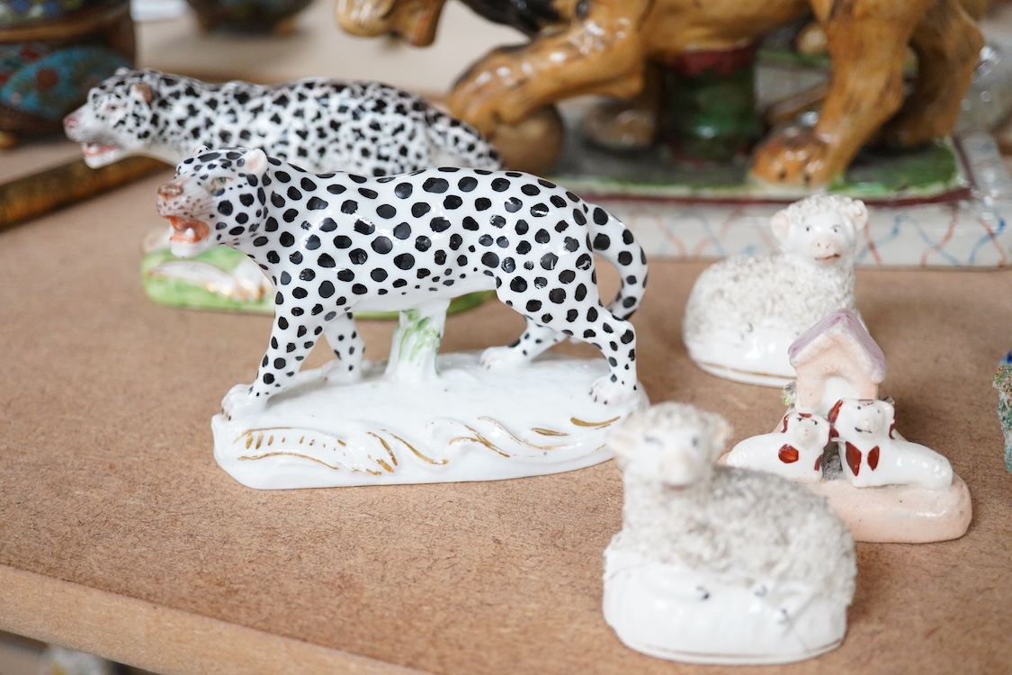 A collection of 19th/20th century Staffordshire and continental porcelain models of animals and birds, including a 20th century Meissen figure of a canary, two Continental porcelain Panthers, two similar recumbent dogs,